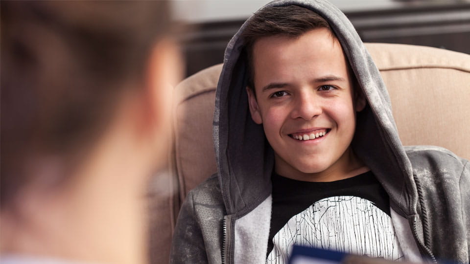 Young person speaking with a social services professional.