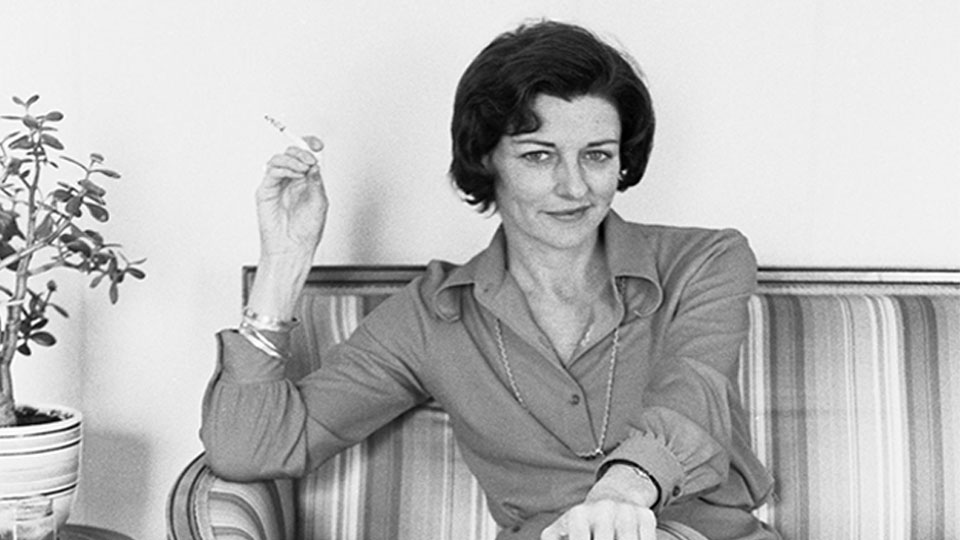Anne Sexton sitting on a sofa holding a cigarette. Taken in 1974 by Arthur Furst
