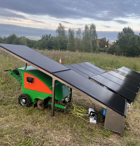The Afrak tractor in its charging bay under the solar panel 