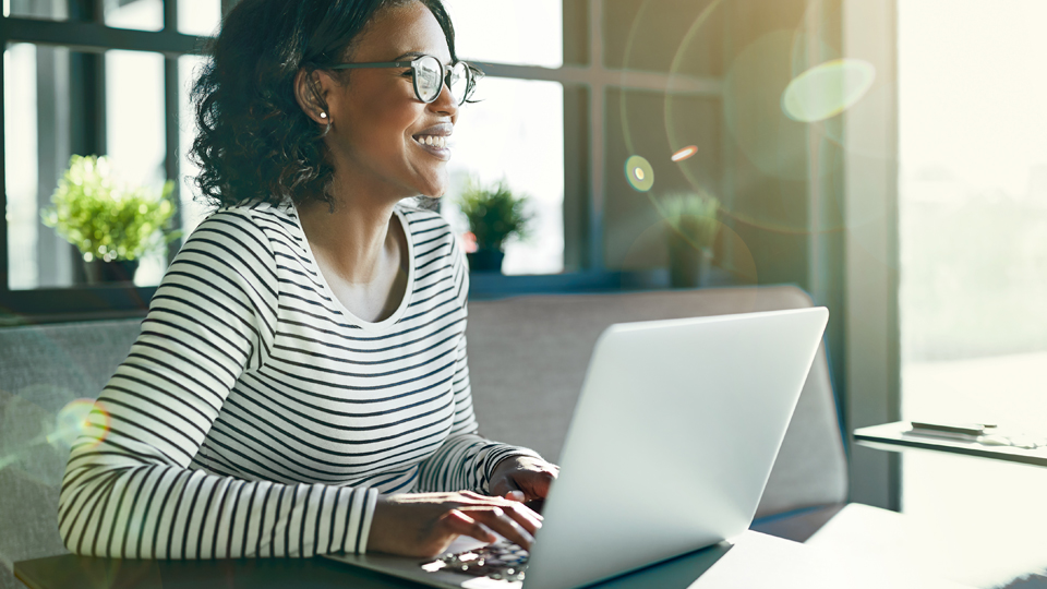 A woman, working on a laptop