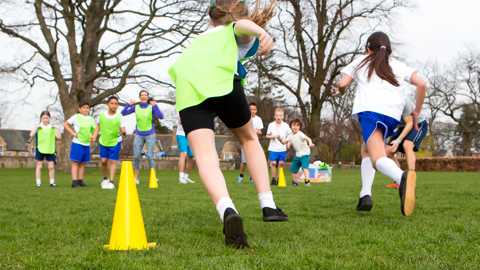 Photograph of school children exercising and running a race