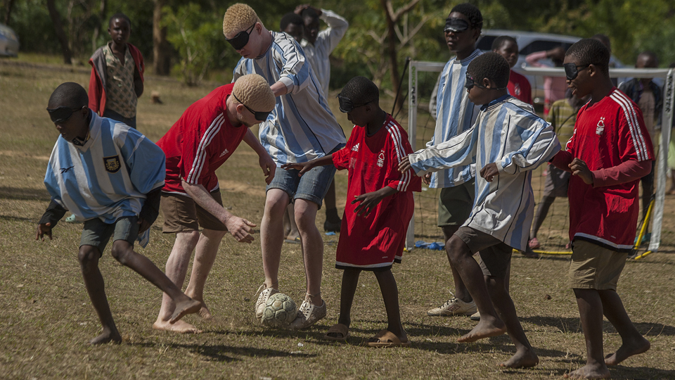 Young people playing blind football