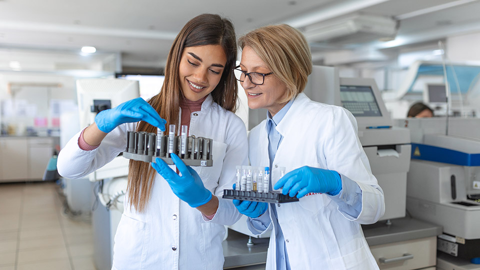 Two women looking at samples in a lab