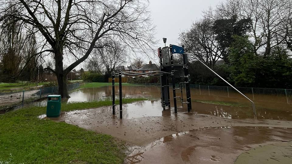 Children's play equipment surrounded by flood water