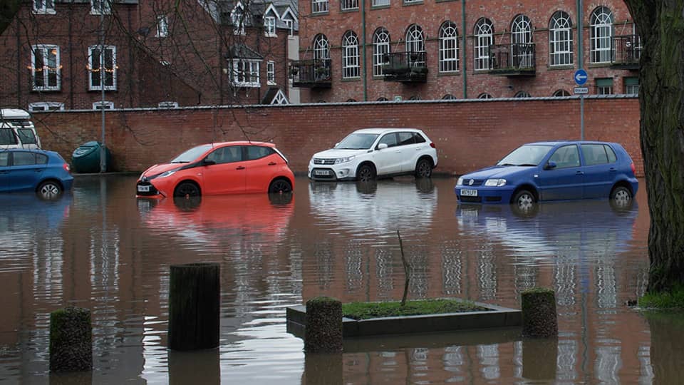 Parked cars surrounded by flood water
