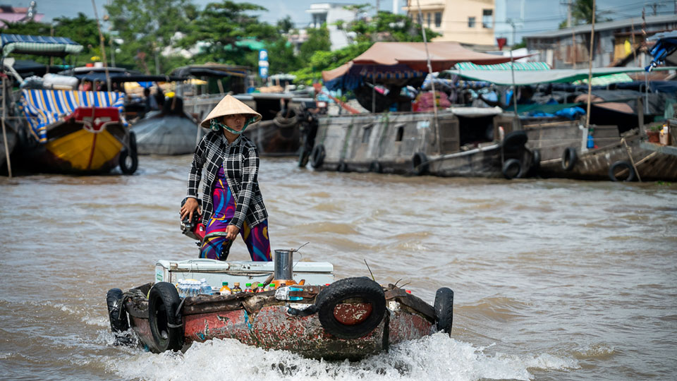 a woman in a speedboad in Mekong delta