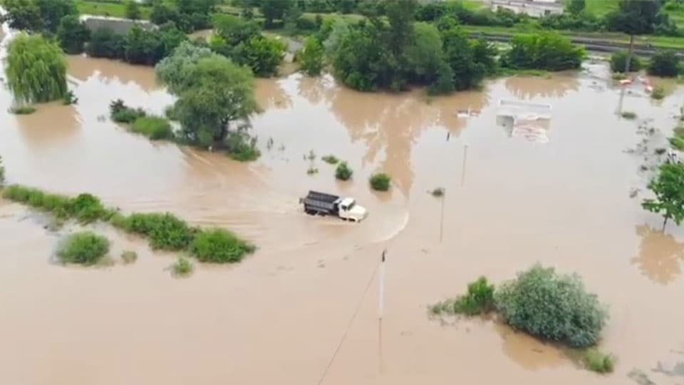 truck driving through flooded area