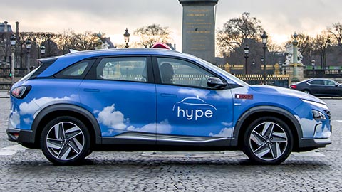 A side-on profile of a modern blue car with the word 'hype' on the driver's door