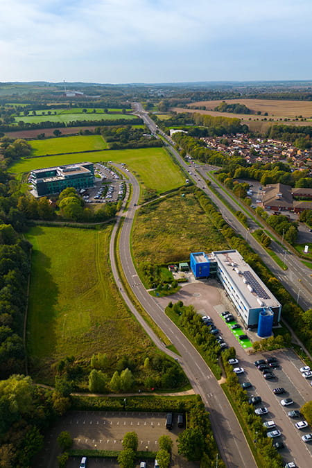 An aerial view of the Loughborough University Science and Enterprise Park showing buildings, green space and main roads