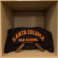 A black sweatshirt with orange lettering 