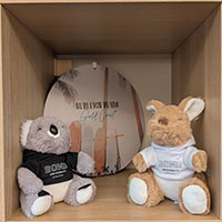 Two soft toys from Bond University and a plaque from Burleigh Heads on the Gold Coast