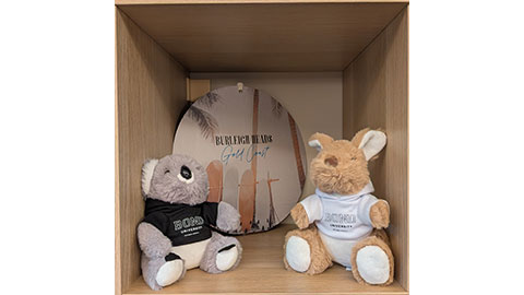 Two soft toys from Bond University and a plaque from Burleigh Heads on the Gold Coast