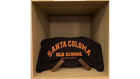 A black sweatshirt with orange lettering 