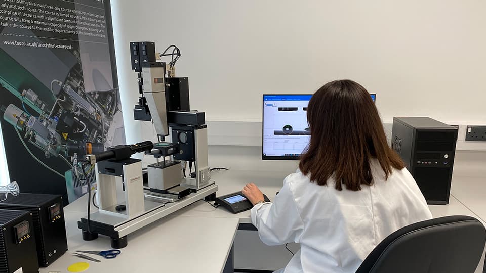 A student sat at the OCA50 contact angle system