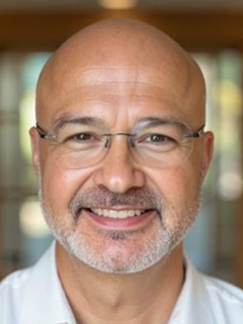 Richard smiling in a professional headshot