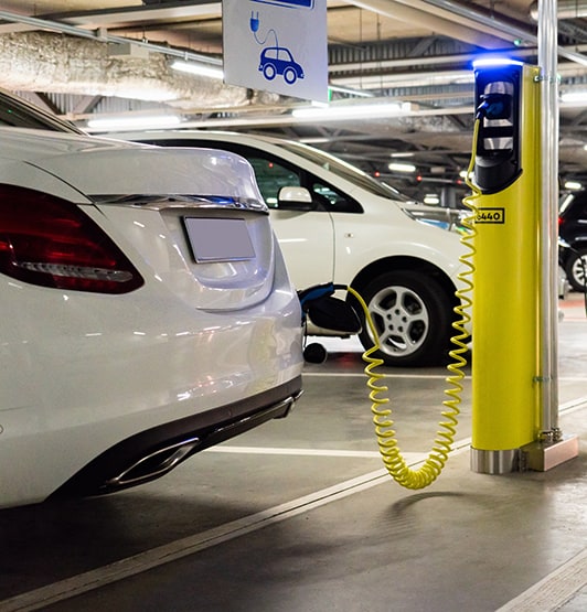 Electric car charging in car park of shopping centre