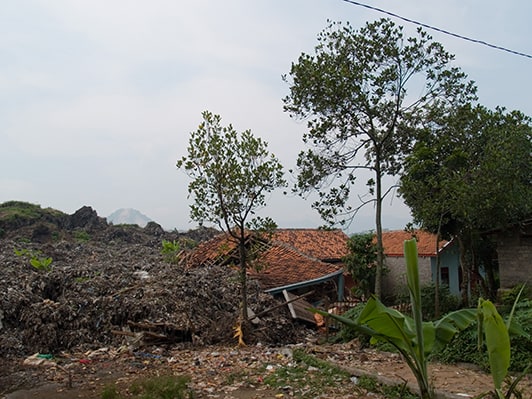 Destroyed village after landslide on a dump near Cimahio, Bandung, Java, Indonesia