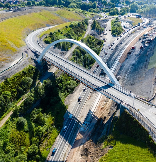 Aerial view of a new suspension bridge above roadworks (A465, Wales)