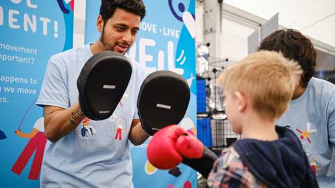 A young visitor taking part in the Boxercise activity