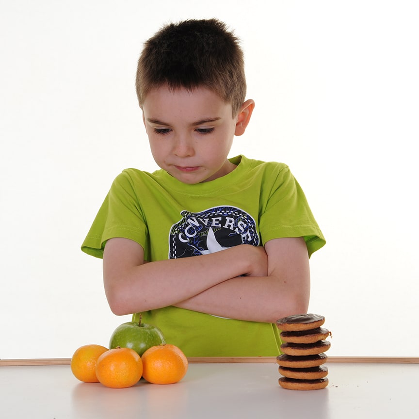 Boy with fruit and biscuits