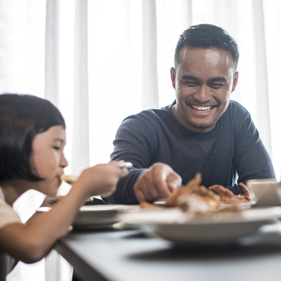 Child and parent eating a meal