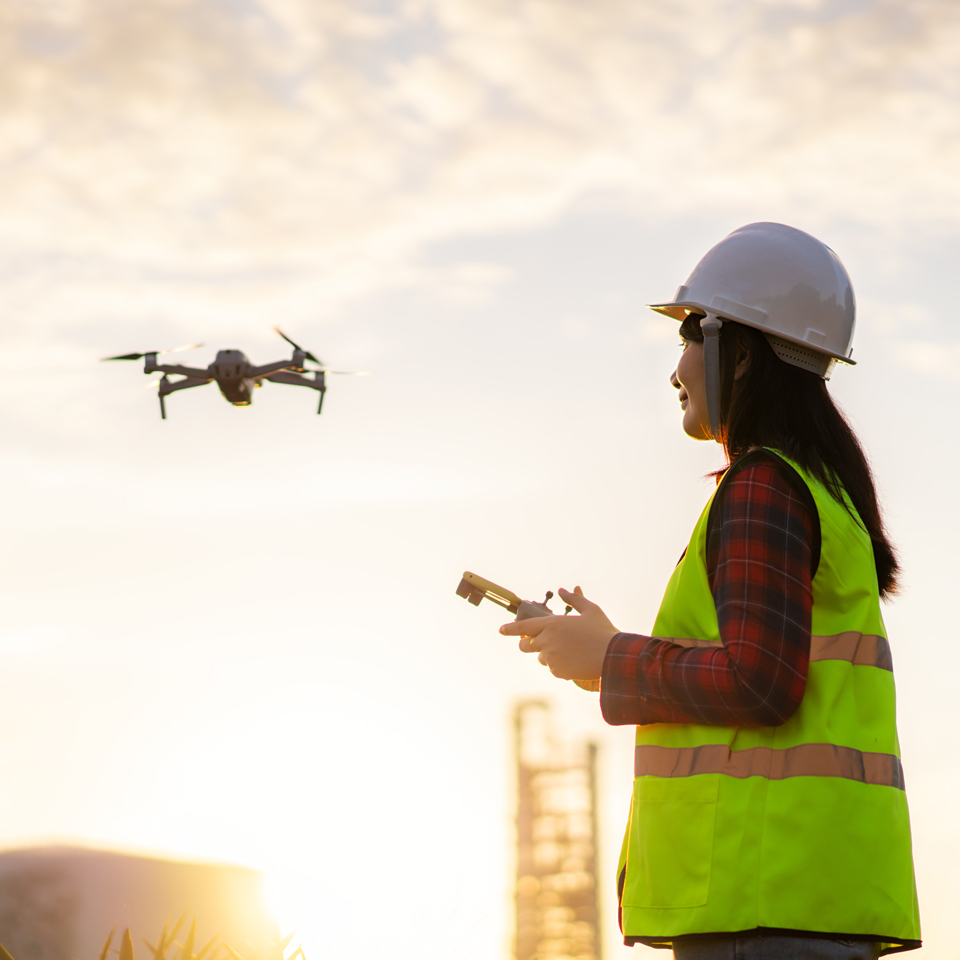Photograph of an engineer operating a drone on a construction site