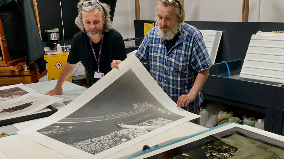 Paul Hill and Alan Duncan inspecting final platinum-palladium prints in the Studio of Light lab