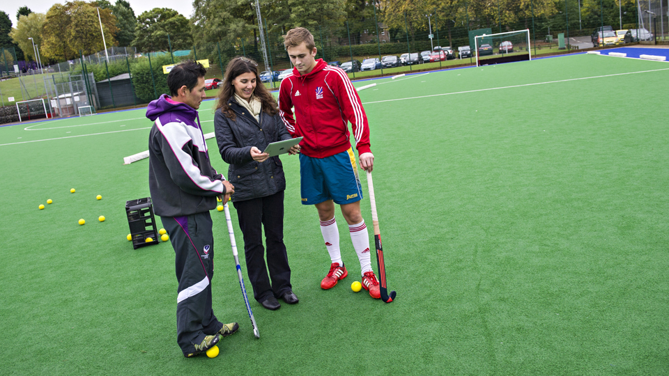 Professor Jowett talking to a hockey coach and player