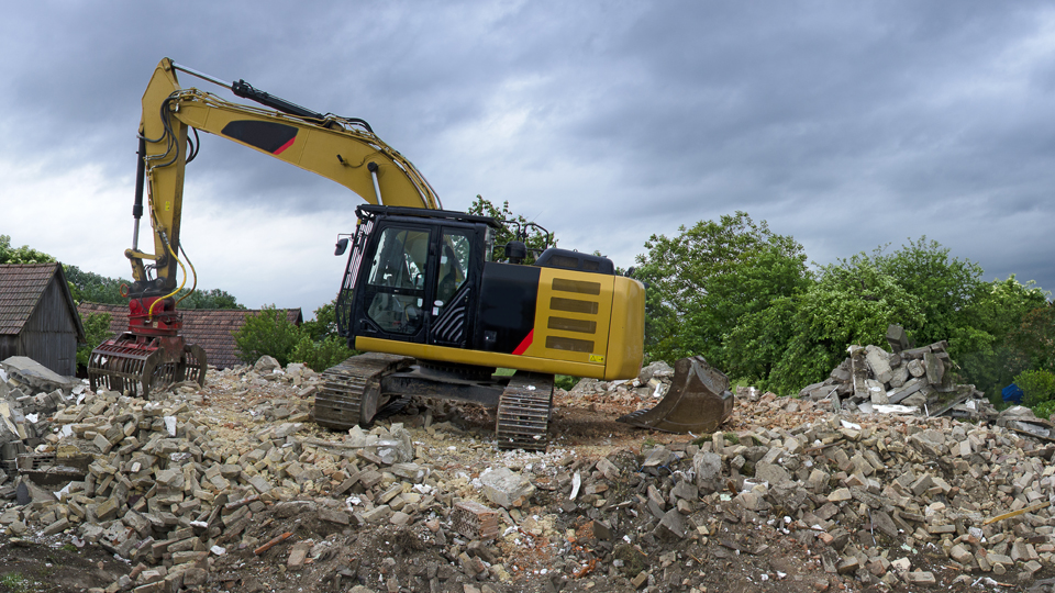 Photograph of a building demolition site strewn with construction waste