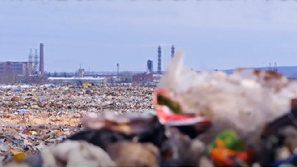 Still from the video, showing a landfill site