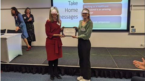 RA Tash Kirk receiving a prize for the best poster at a conference