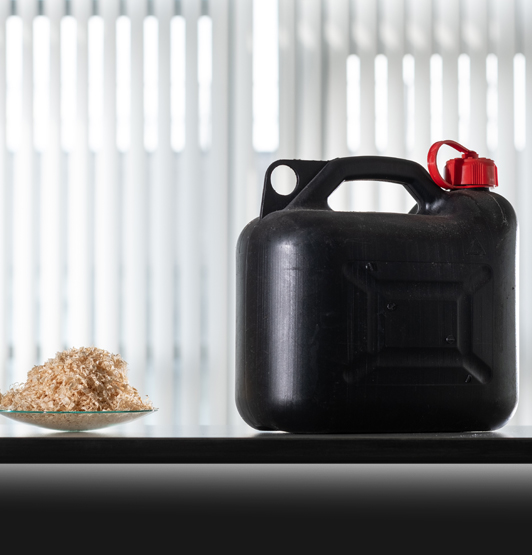 A dish of woodchips beside a petrol can