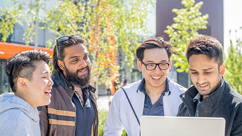 a group of students sitting around a table having a conversation