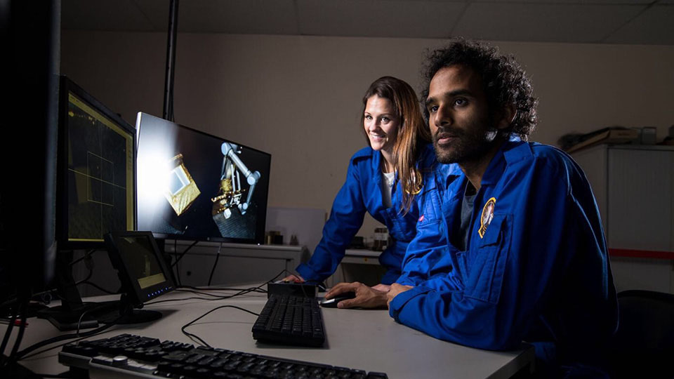 two researchers using computer equipment