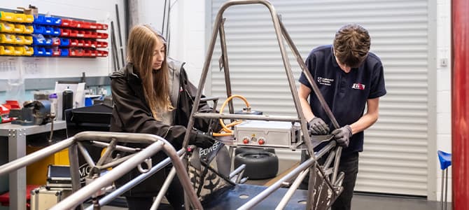 2 students working in formula student garage