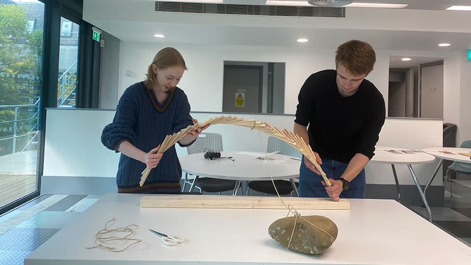 two students working on the Japanese tea house project