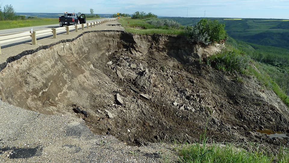 landslides causing significant damage to a road