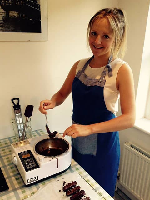 Jennie Sherington handling melted chocolate in a kitchen.
