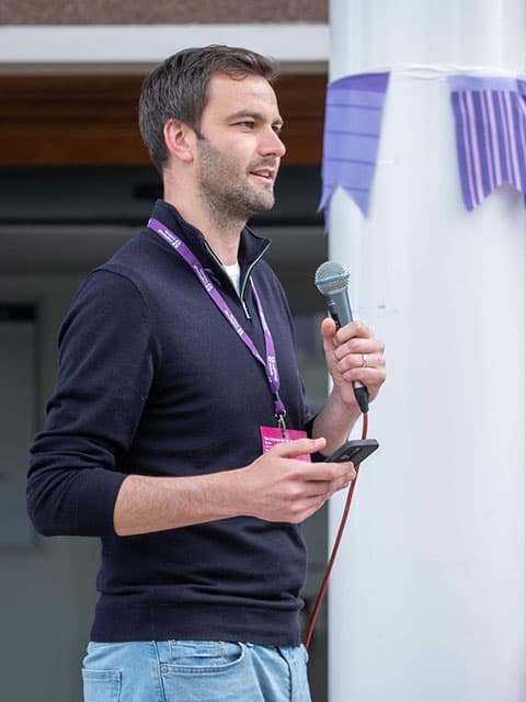 Someone delivering a speech using a microphone.