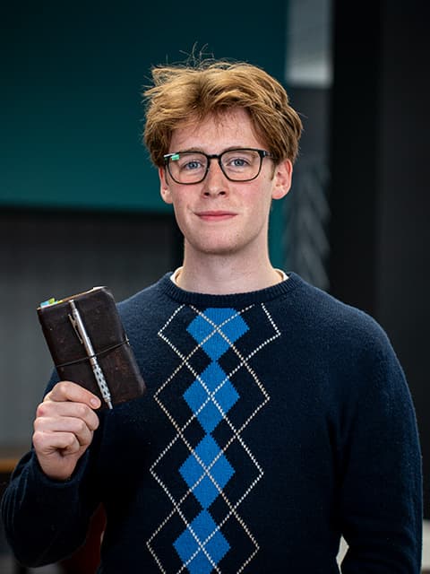 David Thomas holding a journal