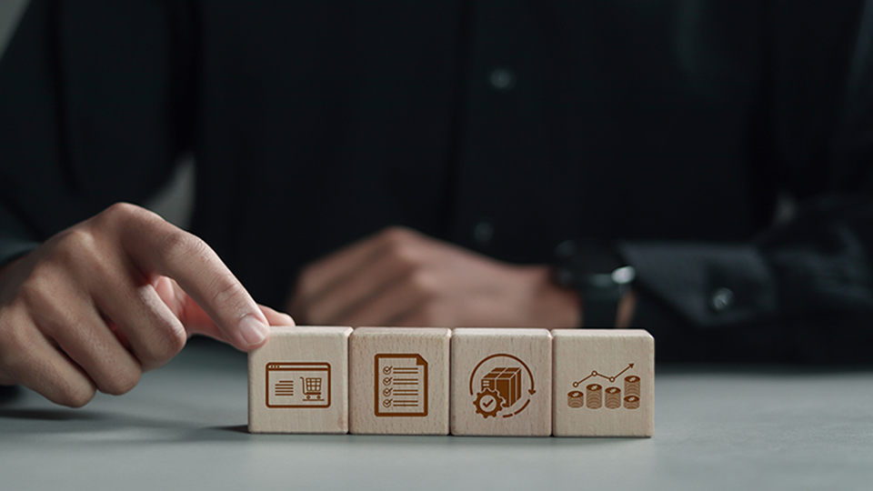 Person interacting with wooden blocks symbolizing e-commerce, task management, logistics, and data analysis.