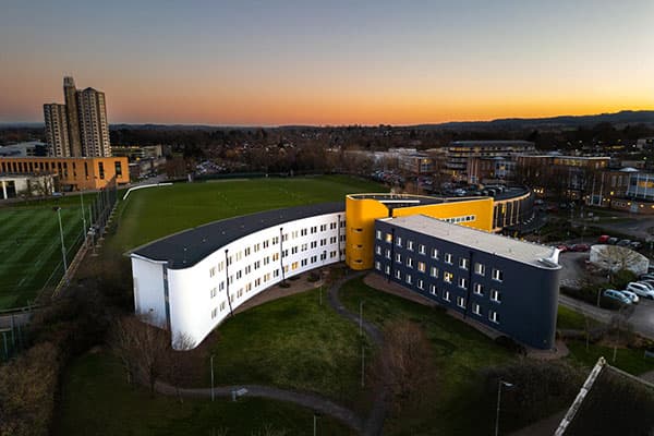 Bird's eye view of the Loughborough Business School building at sunset.