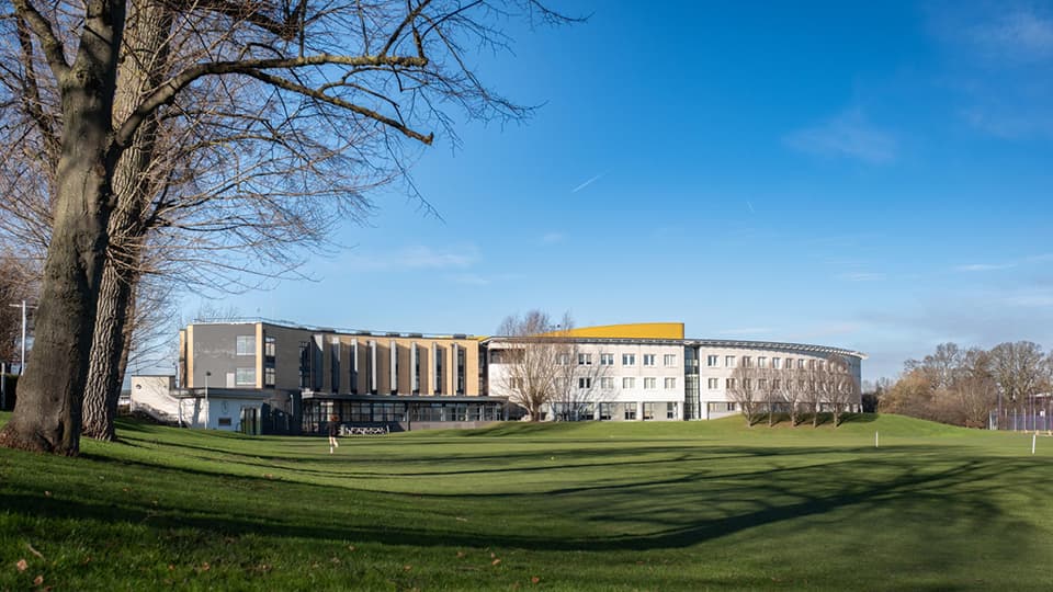 An exterior view of the Loughborough Business School building on a sunny day.