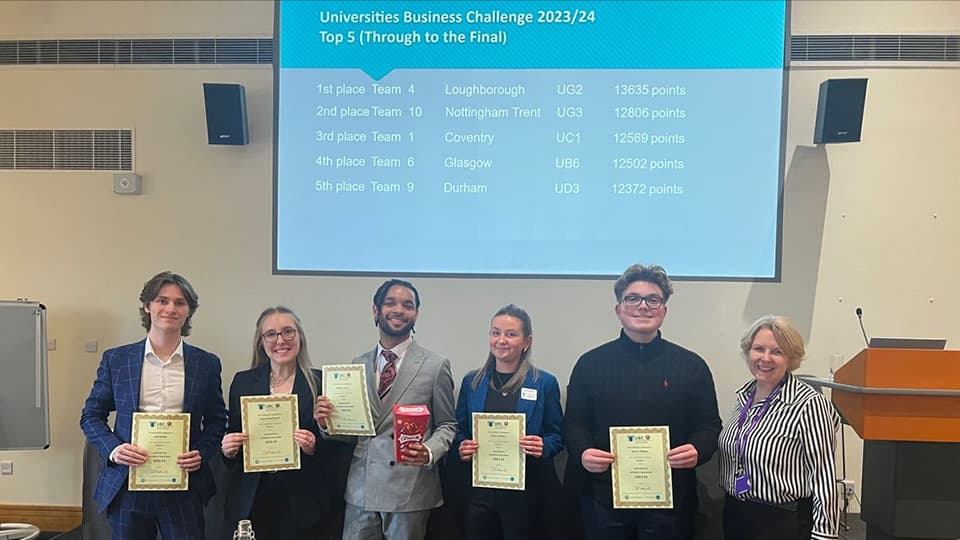 The five students from Team Innovate standing in a row holding certificates, with a representative from UBC beside them.