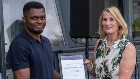 TJ Ekrokpe receives the Doctoral Researcher of the Year award.