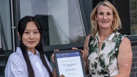 Qian Song receives the Early Career Teacher award.