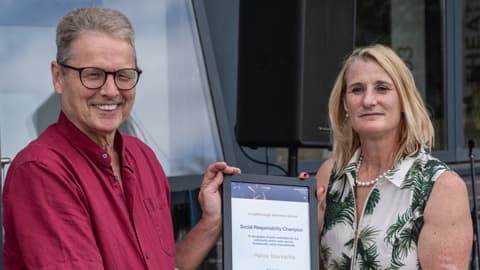 Stephen Frost receives the Social Responsibility Champion Award on behalf of Petros Vourvachis.