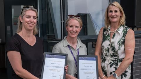 Louise James and Emma Burrow collect the Progress With Purpose: Team of the Year on behalf of the People, Process and Operations and Research and Innovation Teams