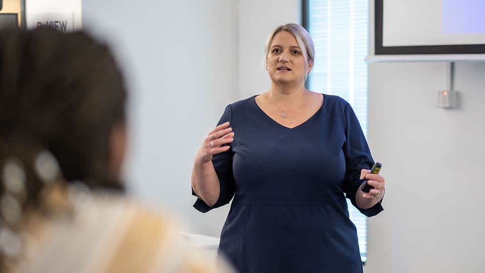 Katherine Martin delivering a lecture to students.