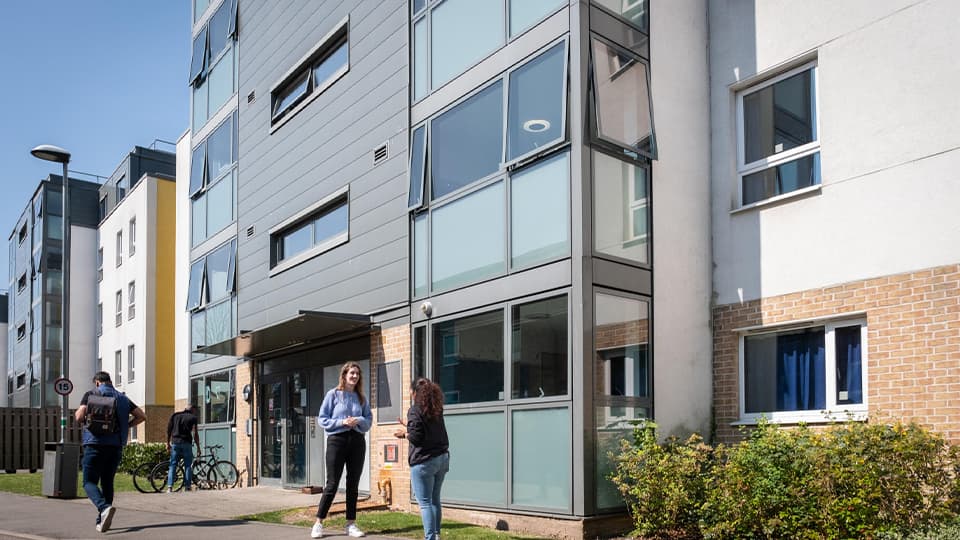 students stood outside accommodation building